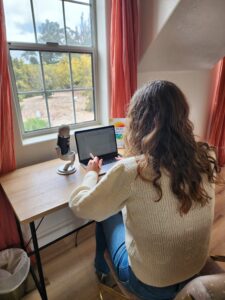 woman at a desk recording a podcast