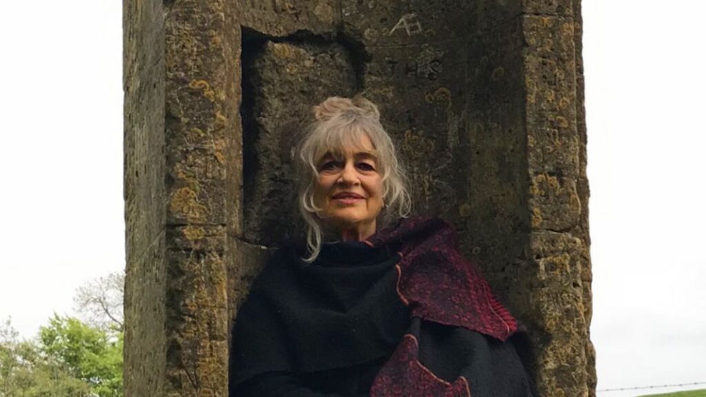 Jill Purce sitting on a stone chair