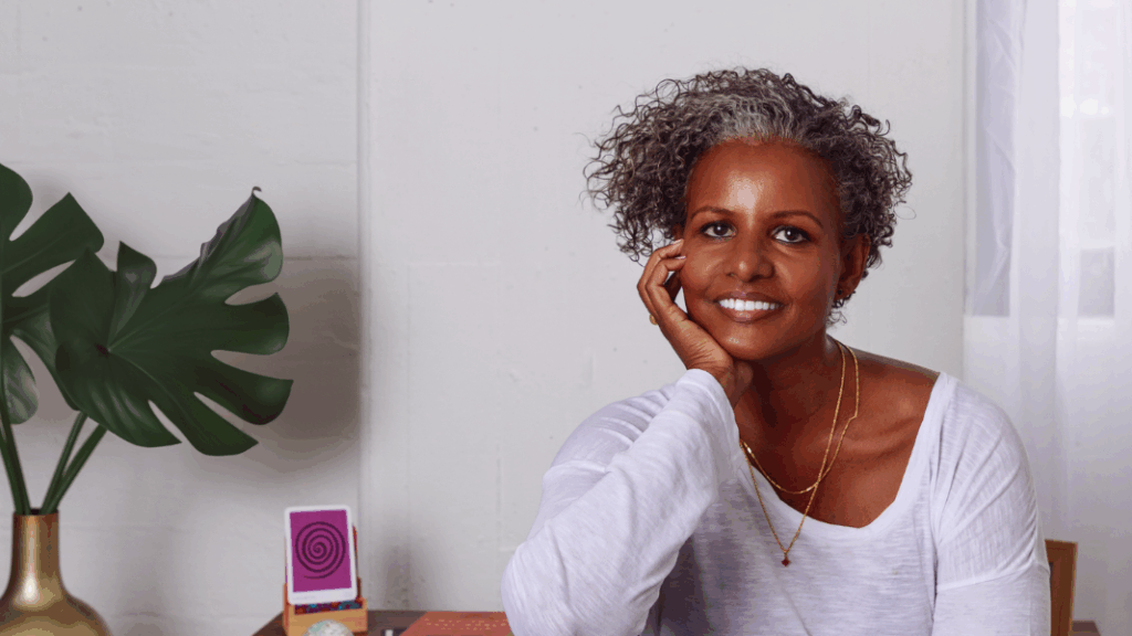 Sebene Selassie sitting at a desk resting chin in hand