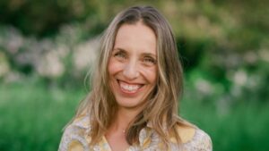 Sarah Seleky smiling in front of a meadow