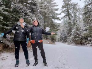 Two guests enjoying a snowy winter day at Song of the Morning Yoga & Meditation Retreat in northern Michigan.