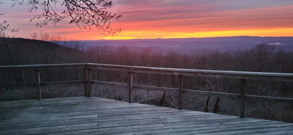 A red and yellow sunset over a purple skyline.