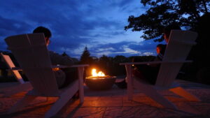 People sitting around a fire pit at dusk